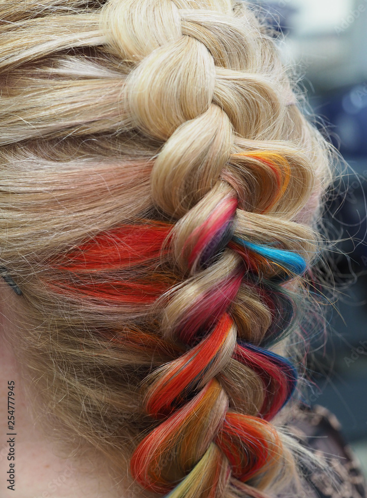 Fototapeta premium Rainbow hair in a braid. Braiding close up.