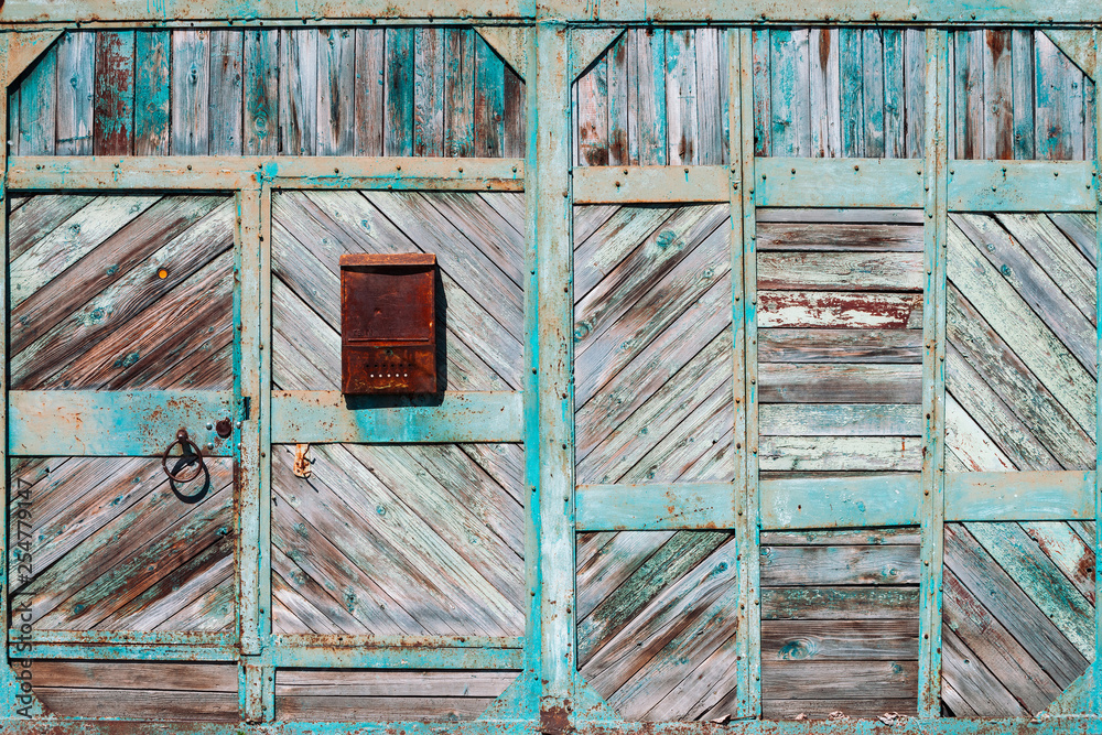 Closed rustic imperfect green garage gate with turquoise peeling paint ...