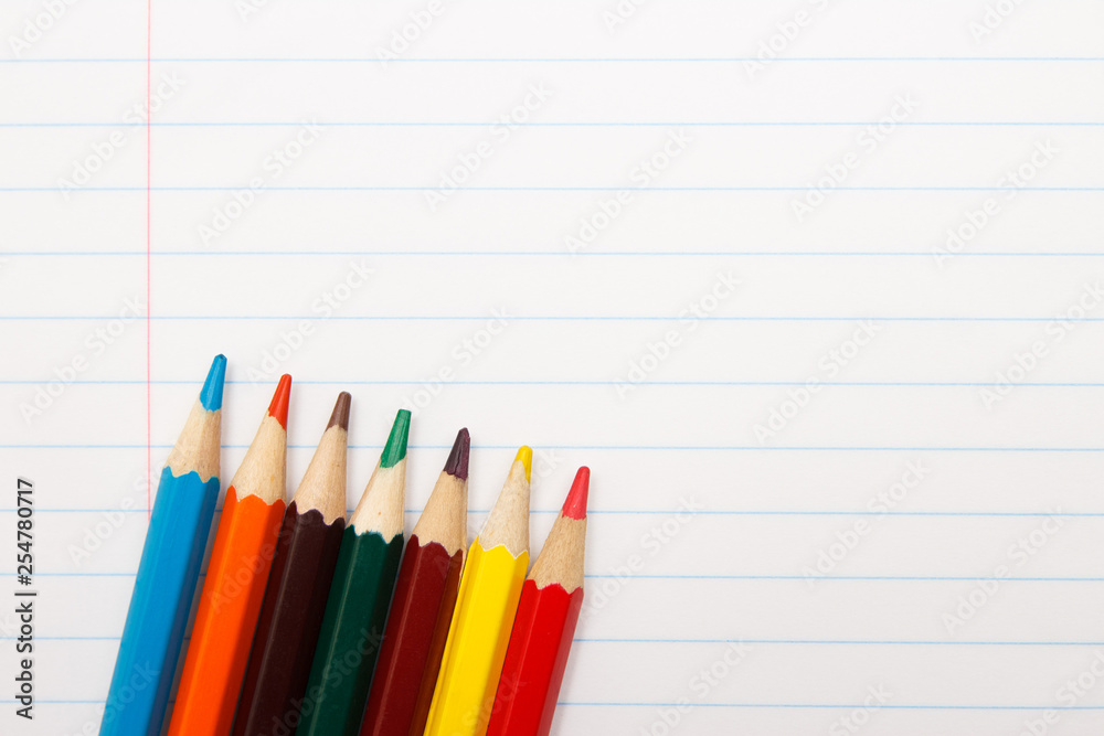 Color pencils on a notebook. Education concept. Copy space. Top view Color pencils on a notebook. Education concept. Copy space. Top view