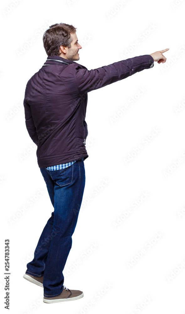 Back view of a man walking with a pointing hand. Back view of a man walking with a pointing hand.