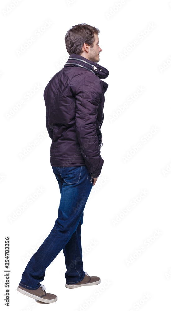 Side view of going handsome man in jeans and jacket. Side view of going handsome man in jeans and jacket.