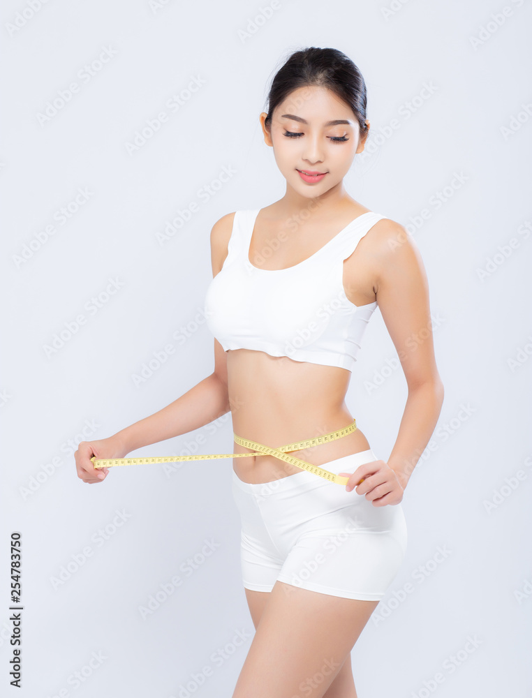 beautiful portrait asian woman diet and slim with measuring waist for weight isolated on white background, girl have cellulite and calories loss with tape measure, health and wellness concept. beautiful portrait asian woman diet and slim with measuring waist for weight isolated on white background, girl have cellulite and calories loss with tape measure, health and wellness concept.