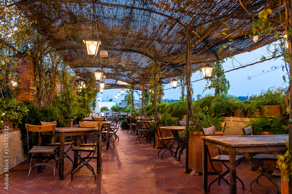 Typical Italian rooftop restaurant wooden tables in Tuscany with covered  roof pergola vine canopy with empty seats, chairs and nobody in rustic  romantic architecture Stock Photo | Adobe Stock
