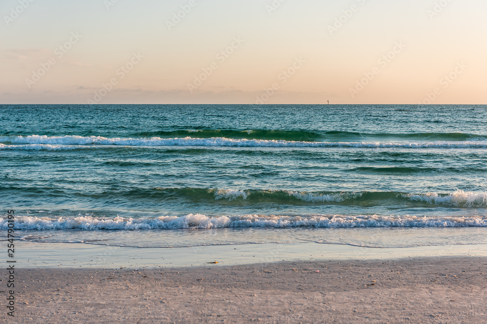 Wave with horizon on shore in Siesta Key, Sarasota, Florida during dark evening sunset with water wet sand tide pool and nobody Wave with horizon on shore in Siesta Key, Sarasota, Florida during dark evening sunset with water wet sand tide pool and nobody