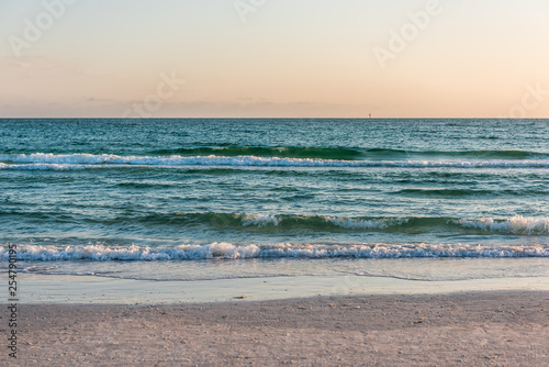 Wave with horizon on shore in Siesta Key  Sarasota  Florida during dark evening sunset with water wet sand tide pool and nobody