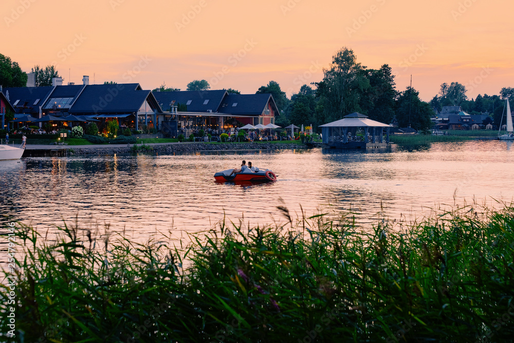 Fototapeta premium Romantic sunset at Street terraced cafe in Galve Lake Trakai