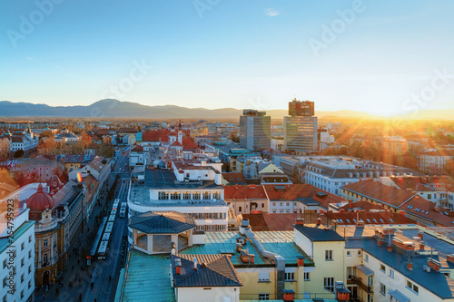 Beautiful sunset with Ljubljana old town and business downtown center, Slovenia. Skyline of European city with Alps mountains. Evening view with scenery and streets landscape. Winter cityscape