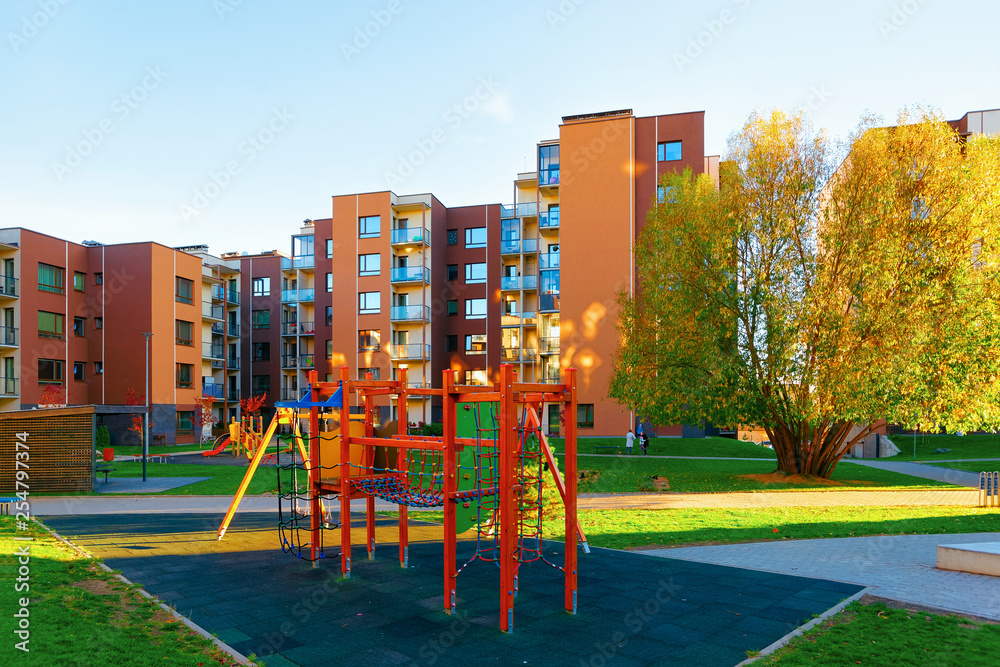 Fototapeta premium Apartment residential house facade architecture with children playground