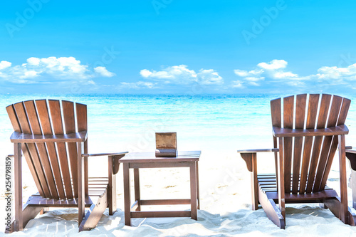 Fototapeta Naklejka Na Ścianę i Meble -  Summer vacation deckchairs on tropical beach and ocean sea background. Travel and vacation background.