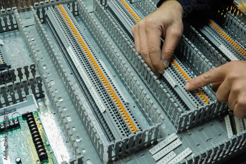 worker assembles automation board