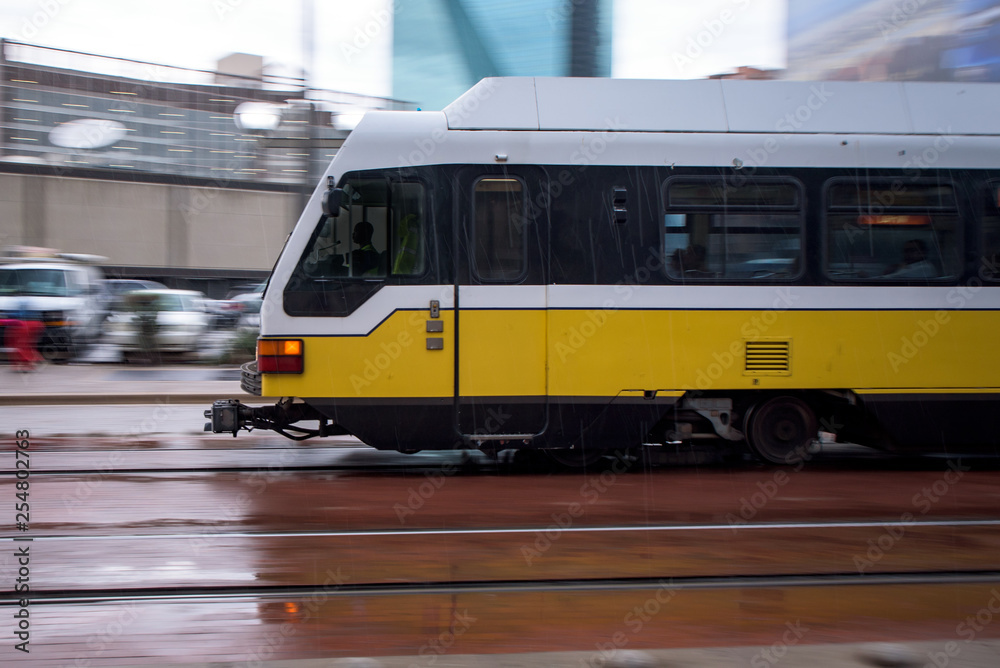 City Train Zooming Through Downtown