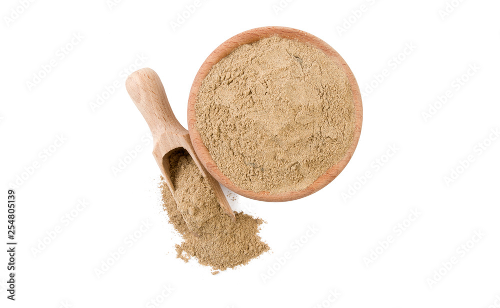 cardamon powder in wooden bowl and scoop isolated on white background. top view. Spices and food ingredients.