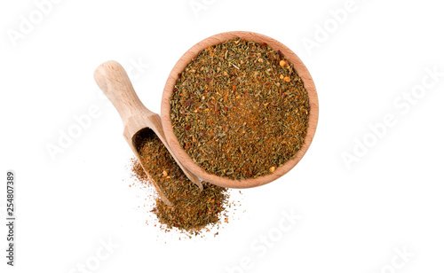 Fototapeta Naklejka Na Ścianę i Meble -  red savory mix or Chubritsa in wooden bowl and scoop isolated on white background. top view. Spices and food ingredients.
