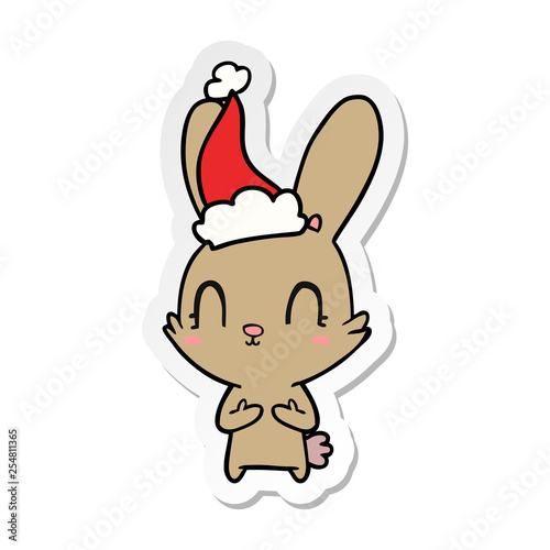 cute sticker cartoon of a rabbit wearing santa hat © lineartestpilot