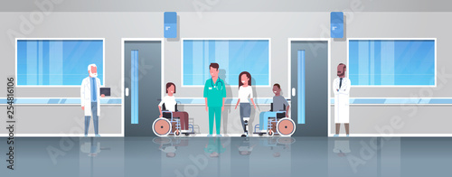 doctors taking care of disabled injured people mix race patients sitting in wheelchair woman with prosthetic leg disability concept hospital corridor clinic interior full length