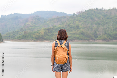 Women shoulder backpack Background mountains and water at Wang Bon dam ,Nakhon nayok in Thailand.
