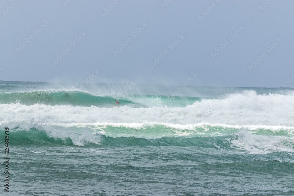 man surfer catching into tube barrel wave from Kirra beach Coolangatta Queensland Gold Coast Australia 