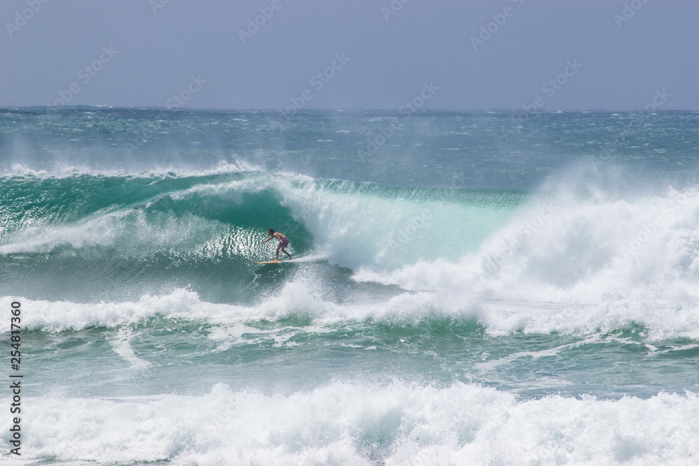 man surfer catching big wave from Kirra beach Coolangatta Queensland Gold Coast Australia cyclone swell