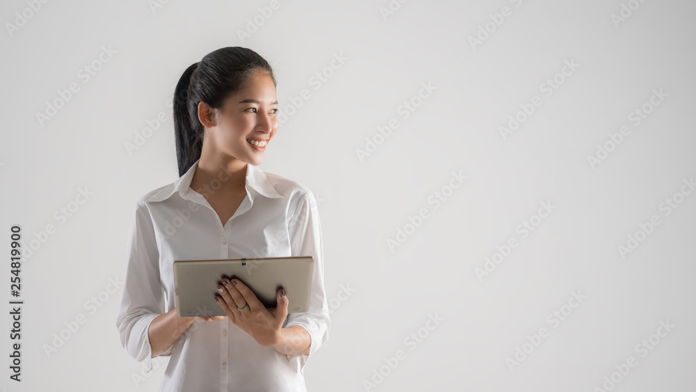 Attractive business woman working on tablet, concept of professional Business person. Attractive business woman working on tablet, concept of professional Business person.