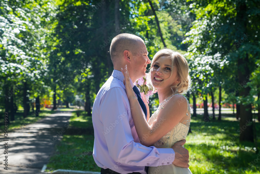 Russian bride and groom together in green city park Russian bride and groom together in green city park