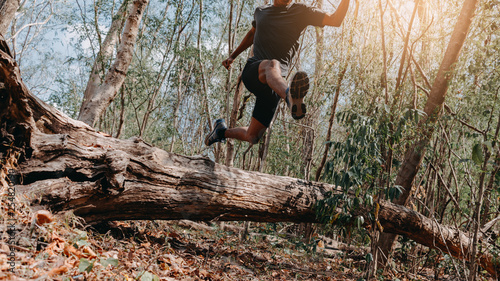 Image of Athlete trail running, runner running on hill.