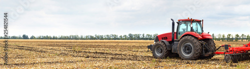 Tractor with plow working in the field
