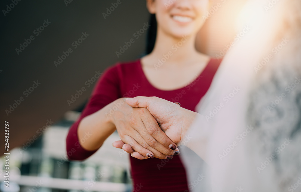 Negotiating business,Image of businesswomen Handshaking,happy with work,the woman she is enjoying with her workmate,Handshake Gesturing People Connection Deal Concept