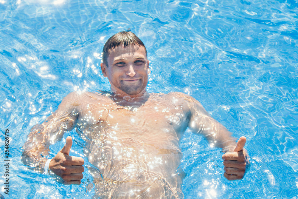 tanned man on vacation swimming in the pool tanned man on vacation swimming in the pool