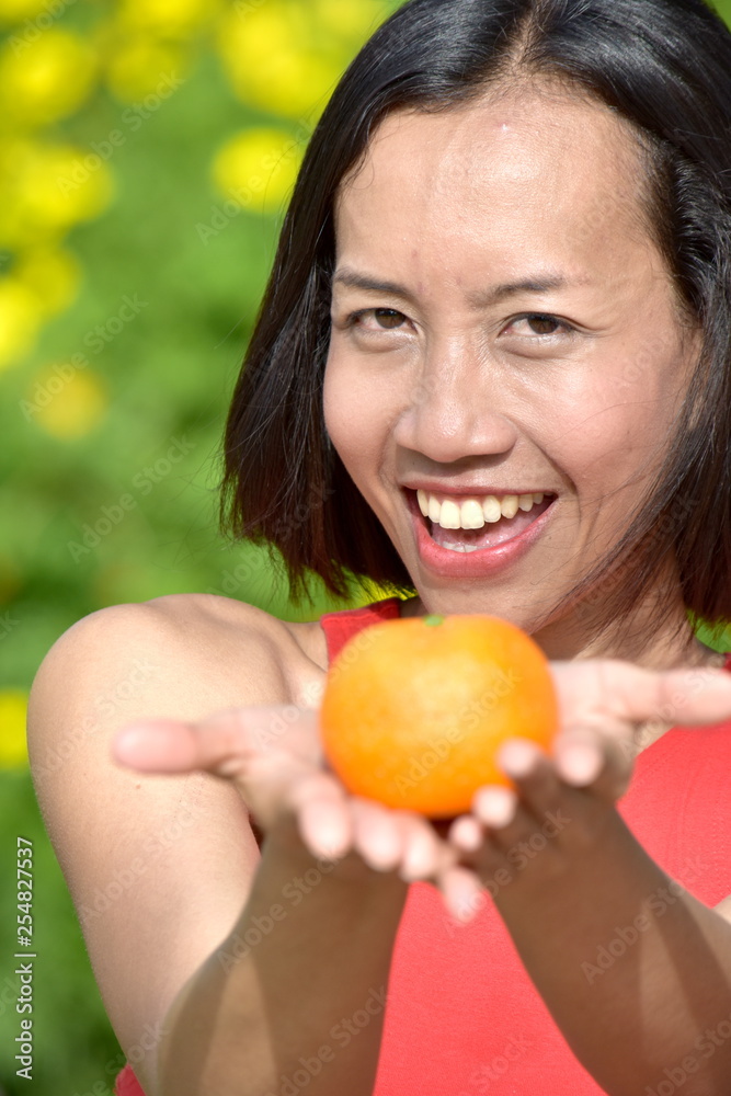 Smiling Attractive Diverse Female With An Orange Smiling Attractive Diverse Female With An Orange