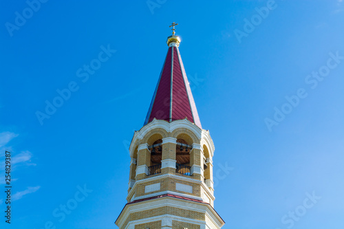 The domes of the Orthodox church against the blue sky, beautiful golden