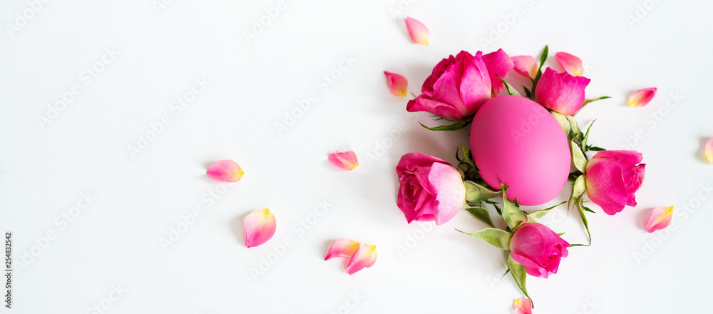 Pink Easter eggs on light background with pink roses. Long wide banner with copy space. Pink Easter eggs on light background with pink roses. Long wide banner with copy space.