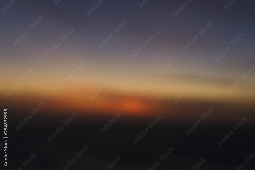 blurred abstract sunset in the clouds background