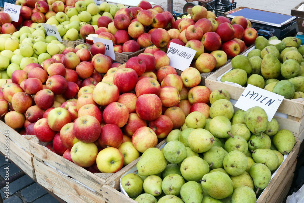 Street market of fresh red and green garden apples fruits in wooden boxes Street market of fresh red and green garden apples fruits in wooden boxes