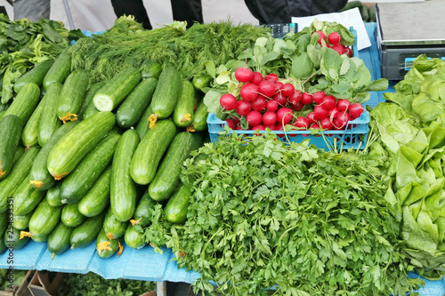Fototapeta Naklejka Na Ścianę i Meble -  fresh  radish parsley and  cucumbers vegetables  in  street stock