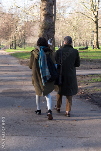 Stylish adult couple walking in the spring park