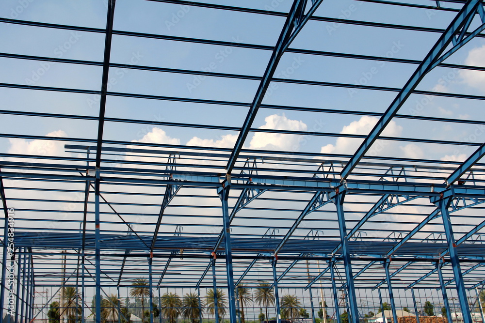 Structure of steel roof frame for building construction on sky background Structure of steel roof frame for building construction on sky background