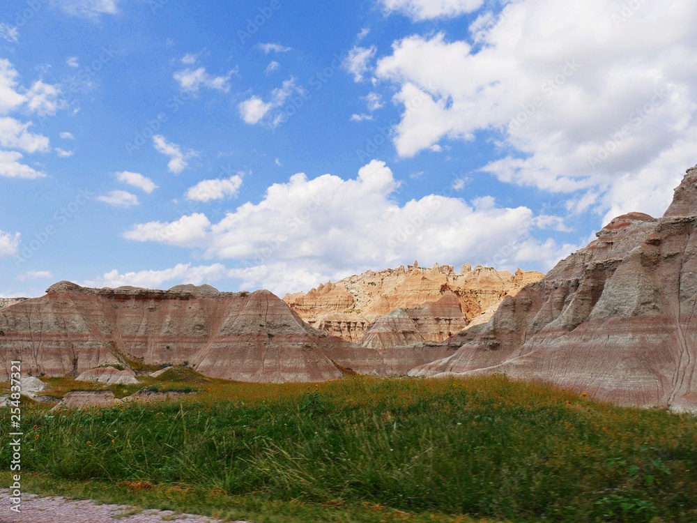 Wide view of the land formations and green prairie at Badlands National Park, South Dakota
