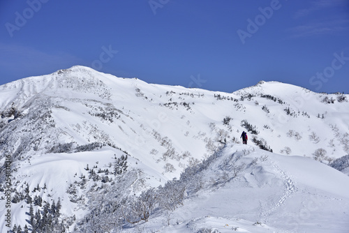 Japan's mountains with snow. Trekker to the summit of Mt.Hotakayama at Gunma Prefecture.  © KnoB