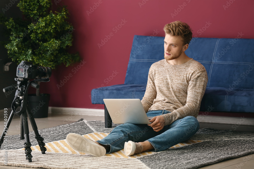 Young male blogger recording video at home Young male blogger recording video at home