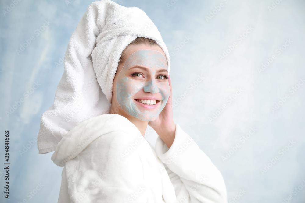 Obraz premium Beautiful young woman with facial mask on light background