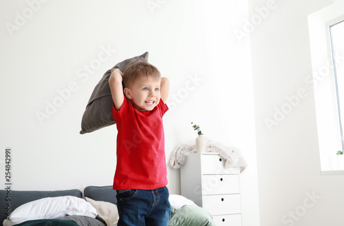 Happy little boy playing wi...
