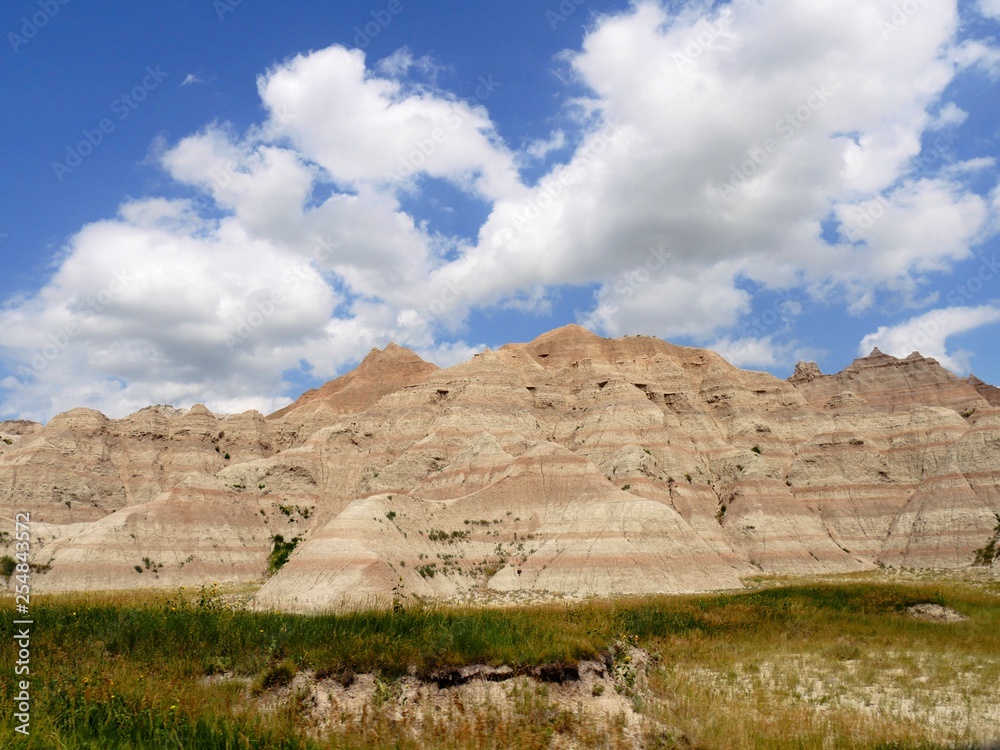 Closer view of the dramatic rock formatoins at Badlands National Park in South Dakota, USA, with gorgeous clouds in the skies.