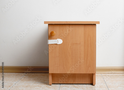Bedside table wooden with baby proofing cabinet lock at home child safety