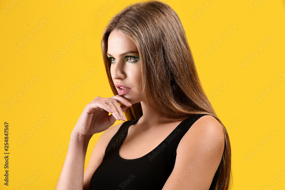 Beautiful young woman with bright makeup on color background Beautiful young woman with bright makeup on color background