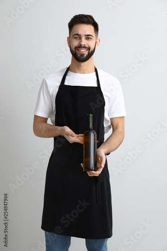 Handsome waiter with bottle...