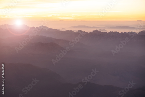 Foggy morning in Italian Alps mountains. Mountain range silhouttes aerial view. © Nickolay Khoroshkov