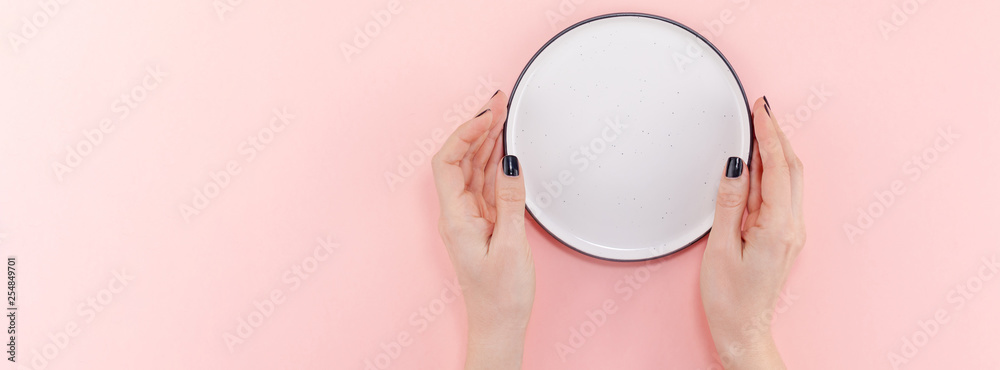 Fototapeta premium Empty plate in female hands mockup