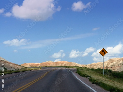 Scenic loop byway at the Badlands National Park in South Dakota, USA, with an arrow on the roadside. 