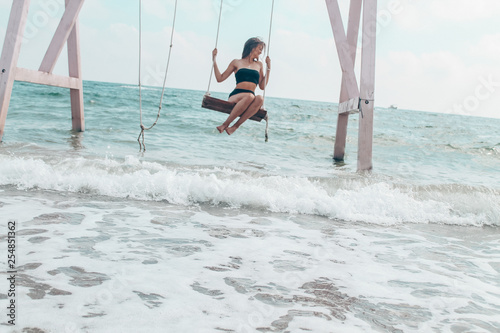 girl on a swing on the beach