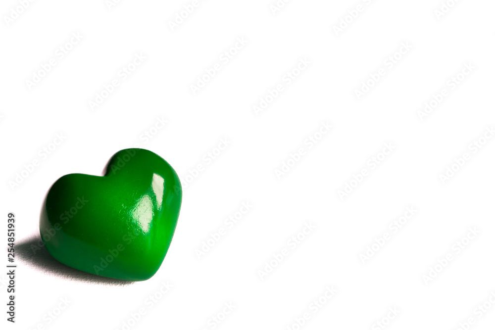 close up of a shiny green 3d heart isolated on white close up of a shiny green 3d heart isolated on white